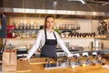 Portrait of young woman standing behind kitchen counter in small eatery Royalty Free Stock Photo